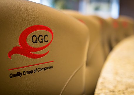 Stitched QGC logo on the back of conference room chairs